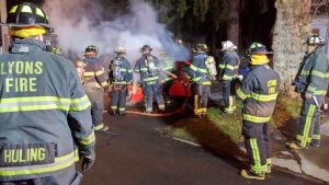 Lyons Firemen working to put out a vehicle fire.